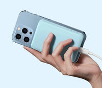 Hand holding a smartphone with a light blue case against a light gray background