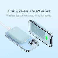 Phone with wireless and wired charging capabilities on a light blue background